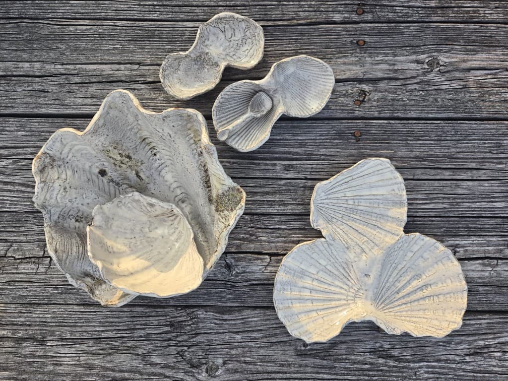 Finished shell ceramics from the kiln on weathered wood